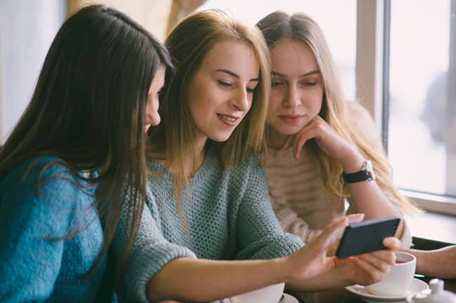 kobieta używająca telefonu i laptopa